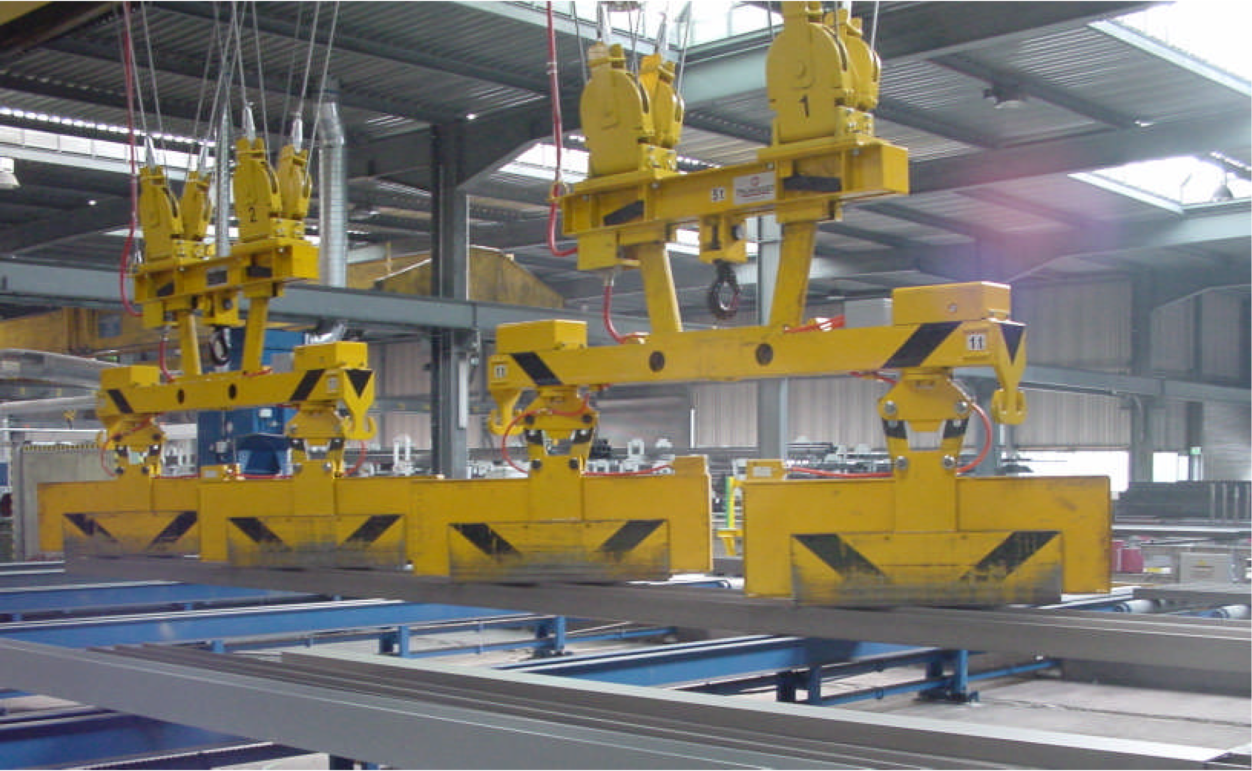 Two individual spreader beams with anti-sway V-shape rope guidance for lifting of beams.